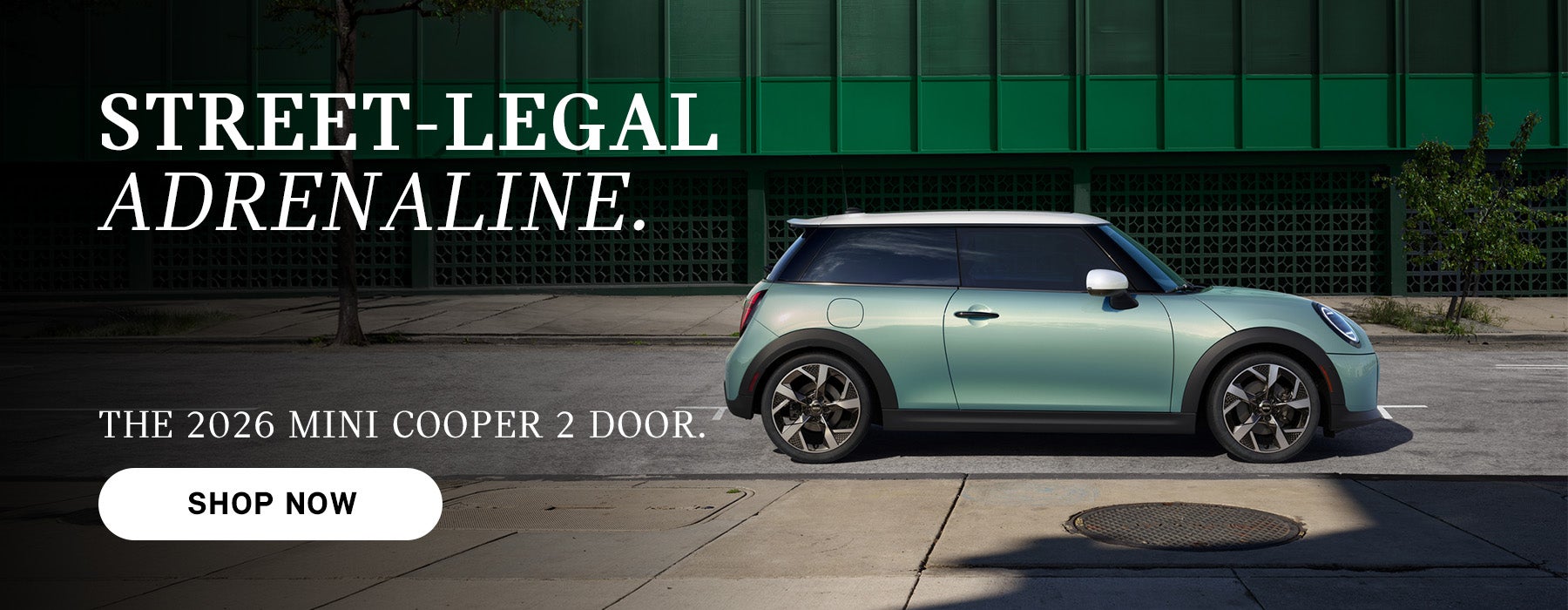 Mint green MINI Cooper 2-door parked on a city street with building backdrop, with ad text promoting the 2026 model 