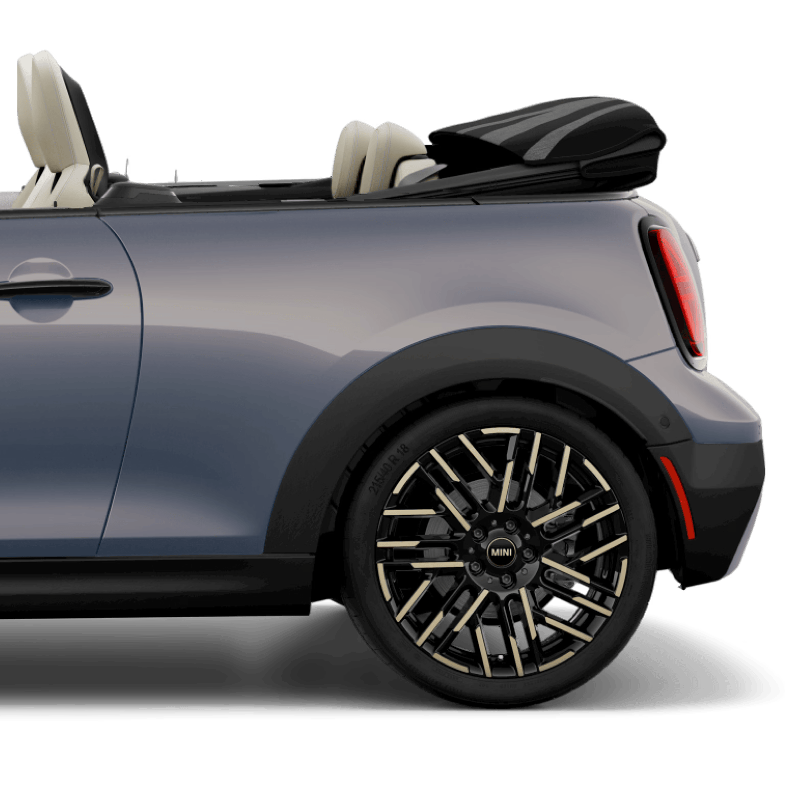 Side view of the rear of a MINI Cooper S Convertible, parked on a blank white surface with its shadow underneath it and nothing in the background.