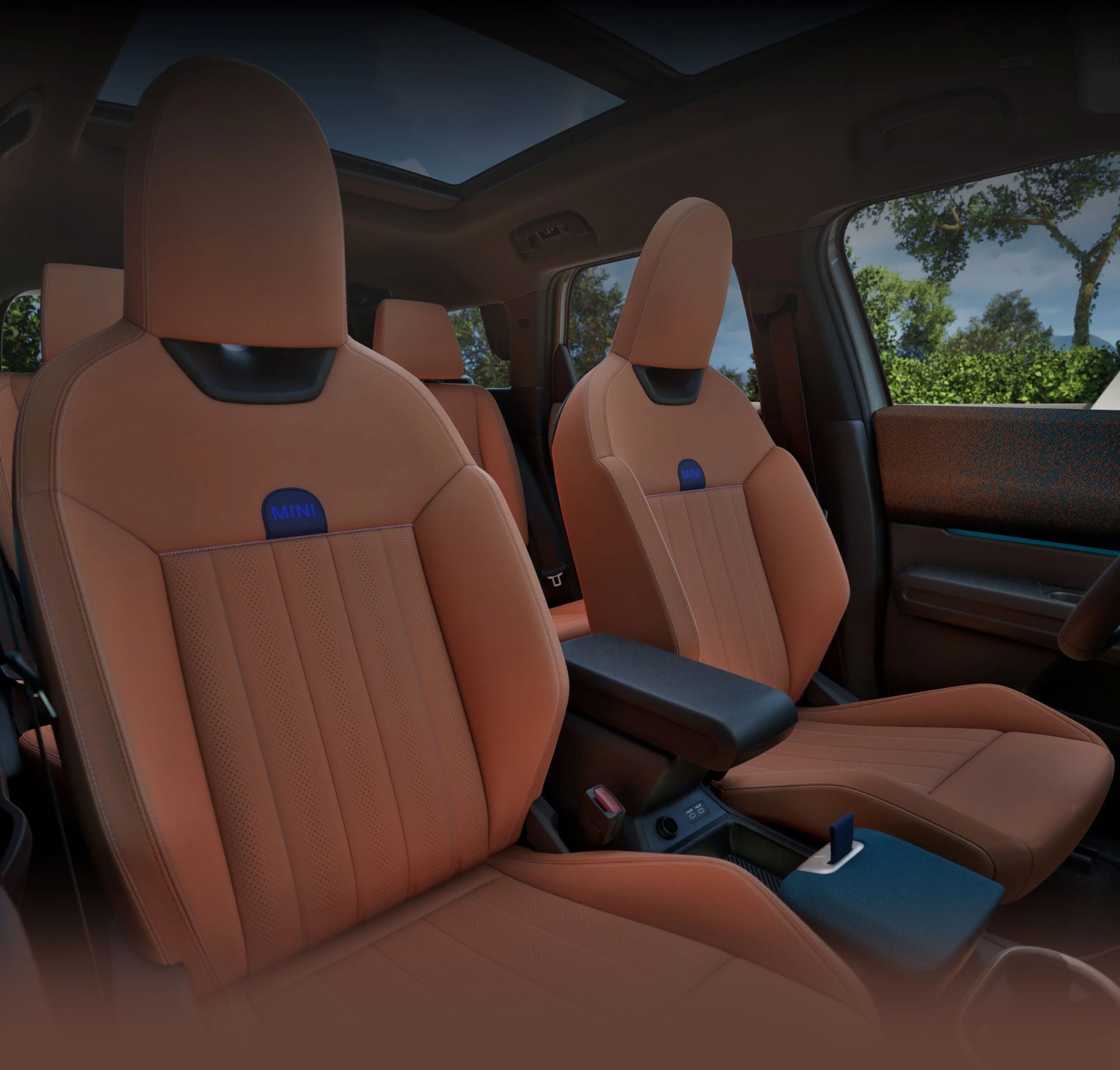 ountryman S ALL4 taken from the passenger's side showcasing the front Sports Seats with blue skies and trees out the windows.