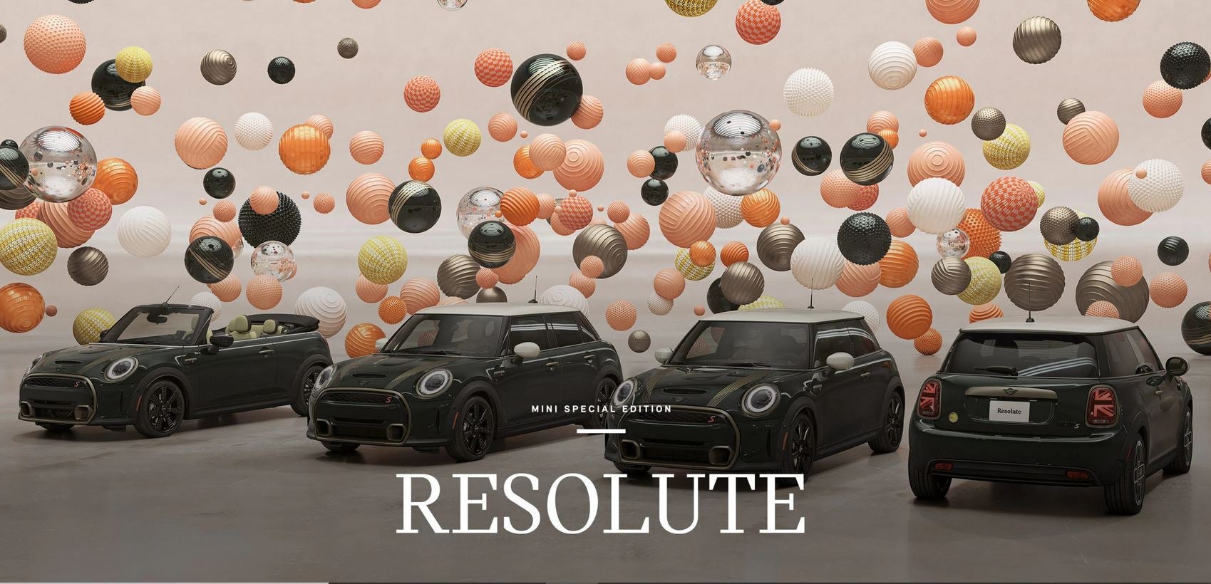 Overhead three-quarter view of four MINI Resolute Editions, a 2-Door, 4-Door, Convertible, and Electric, in a CGI world filled with floating, multi-color and multi-texture balls.