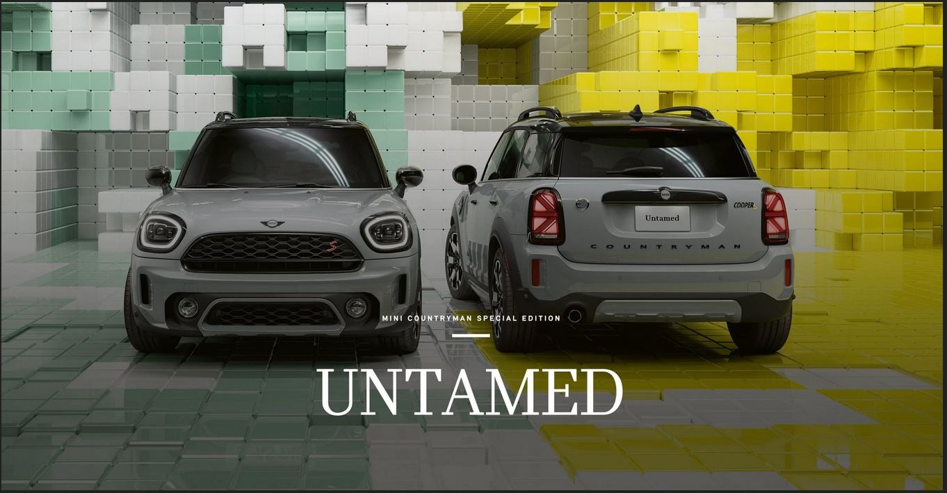 Front view of a MINI Cooper S Countryman Untamed Edition next to a back view of a MINI Cooper SE All4 Countryman Untamed Edition, in a CGI world made up of 3D, Tetris-like boxes.